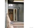 Inviting front entry featuring a wood door, sidelight window, and overhead light at 2770 Arbor Glen Pl, Boulder, CO 80304