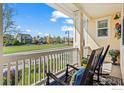 Relaxing front porch view with rocking chairs overlooking a well-manicured lawn and neighborhood scenery at 2827 Twin Lakes Cir, Lafayette, CO 80026