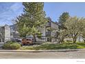 Exterior view of condo building with multiple levels and balconies, surrounded by trees and landscaping at 3363 Oneal Pkwy # 36, Boulder, CO 80301