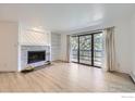 Open living room with a fireplace, built-in shelving, and a sliding glass door to balcony at 3363 Oneal Pkwy # 36, Boulder, CO 80301