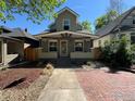 Charming home with a covered front porch, brick walkway, and inviting curb appeal at 3440 W 33Rd Ave, Denver, CO 80211