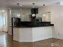 Modern kitchen with stainless steel appliances, granite countertops, and pendant lighting at 3440 W 33Rd Ave, Denver, CO 80211