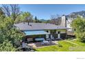 Relaxing backyard patio area with awning and seating, perfect for entertaining at 3735 Britting Ave, Boulder, CO 80305