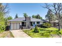 Landscaped front yard featuring a charming ranch-style home with an attached garage at 3735 Britting Ave, Boulder, CO 80305