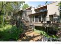 Multi-level deck with wrought iron railings, perfect for outdoor dining and relaxation in a serene setting at 3945 Promontory Ct, Boulder, CO 80304