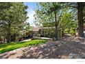 Spacious deck offering ample seating and dining areas surrounded by lush greenery and mature trees at 3945 Promontory Ct, Boulder, CO 80304