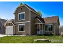 Beautiful two-story home with attached garage and inviting entrance with lawn and landscaping at 5298 S Zeno Way, Centennial, CO 80015