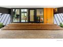 Stylish home entrance featuring a wood deck, sleek planters, and modern architectural details at 630 Northstar Ct, Boulder, CO 80304
