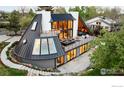 Unique modern home showcasing a distinctive roof design, spacious deck and lush landscaping at 630 Northstar Ct, Boulder, CO 80304