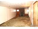 Living room featuring carpet, brick fireplace, accent lighting, and built-in shelving at 6363 County Road 20, Longmont, CO 80504