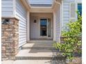 Covered front porch with stone accents, providing a charming entryway to the home at 6721 E 114Th Ave, Thornton, CO 80233