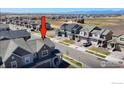 An aerial shot showcases this charming neighborhood with mountain views, featuring well-maintained homes at 700 Lillibrook Pl, Erie, CO 80026