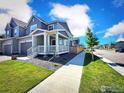 A well-maintained home with manicured lawn and sidewalk leading to neighboring houses at 700 Lillibrook Pl, Erie, CO 80026