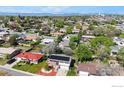 Aerial view showcasing a two story house with solar panels surrounded by a lush, green neighborhood at 8351 Ralph Ln, Denver, CO 80221