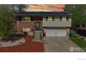 Charming split-level home featuring solar panels, a manicured yard, and a two-car garage at 8351 Ralph Ln, Denver, CO 80221