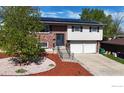 Charming split-level home featuring solar panels, a manicured yard, and a two-car garage at 8351 Ralph Ln, Denver, CO 80221