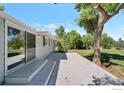 A home's exterior has a sliding glass door which leads to a patio at 8813 Baseline Rd, Lafayette, CO 80026