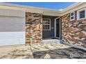 Close-up of a brick home's front entrance, highlighting the unique brickwork at 10723 Loren Ln, Northglenn, CO 80233