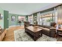Bright living room featuring hardwood floors, large windows, and comfortable seating at 10723 Loren Ln, Northglenn, CO 80233