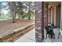Outdoor patio space featuring an iron table and chairs, framed by brick columns at 1089 Laramie Blvd, Boulder, CO 80304