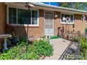 Inviting front porch with charming details and well-maintained landscaping at 111 Barbara St, Louisville, CO 80027