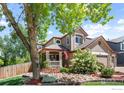 Charming two-story home with well-maintained landscaping, a welcoming front porch, and a three-car garage at 1500 Red Mountain Dr, Longmont, CO 80504
