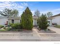 Well-maintained single-story home featuring mature trees and manicured landscaping in the front yard at 1650 Bedivere Cir, Lafayette, CO 80026