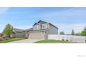 Beautiful two-story home featuring a manicured lawn and white fence at 1725 Exeter St, Berthoud, CO 80513