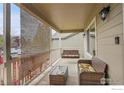 Relaxing covered porch with comfortable seating and a charming swing at 1725 Exeter St, Berthoud, CO 80513