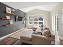Bright living room with a vaulted ceiling, large window, and stylish furniture creating a cozy atmosphere at 210 S Cherrywood Dr # 303, Lafayette, CO 80026
