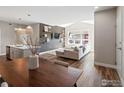 Open-concept living area featuring modern furnishings and dark-stained hardwood flooring throughout at 210 S Cherrywood Dr # 303, Lafayette, CO 80026