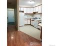 Efficient kitchen featuring white cabinets and appliances at 2295 E Asbury Ave # 205, Denver, CO 80210