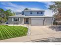 Charming two-story home with landscaped front yard and attached three-car garage at 2410 Key Ct, Longmont, CO 80501