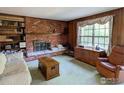 The living room features a brick fireplace with built-in shelves and bright natural lighting at 2434 S Kirkwood Ct, Denver, CO 80222