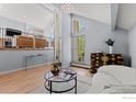 Stylish living room with hardwood floors, high ceilings, and views of the second story at 3075 Galena Way, Boulder, CO 80305