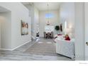 Bright living room featuring vaulted ceilings, modern decor, and wood-style flooring at 3117 Cimarron Pl, Superior, CO 80027