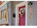 Close up of the front door with a decorative wreath and house number at 3207 N Marion St, Denver, CO 80205