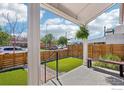 Cozy front porch featuring a bench, privacy fence, and green turf at 3207 N Marion St, Denver, CO 80205