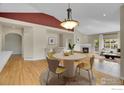 Open-concept dining room with hardwood floors and a modern chandelier at 3742 Florentine Cir, Longmont, CO 80503