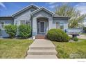 Welcoming front entrance with concrete steps and walkway to the door at 3742 Florentine Cir, Longmont, CO 80503