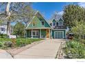 Green two-story home with driveway, garage and charming curb appeal at 485 Grape Ave, Boulder, CO 80304