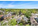 Aerial view of a residential neighborhood with tree-lined streets and various home styles at 486 N Corona St, Denver, CO 80218