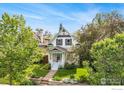 Charming two-story home with a well-maintained lawn and mature trees at 486 N Corona St, Denver, CO 80218
