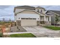 Inviting two-story home with a two-car garage, landscaped front yard, and stone accents at 5881 Aspenglow St, Longmont, CO 80504