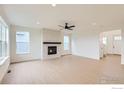 Bright living room features a modern fireplace, large windows, and wood floors at 5881 Aspenglow St, Longmont, CO 80504