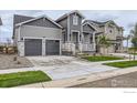 Attractive two-story home with a two-car garage and well-maintained lawn, showcasing its curb appeal at 5891 Aspenglow St, Longmont, CO 80504