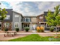 Inviting townhome community featuring well-maintained landscaping and pleasant outdoor seating at 749 Robert St, Longmont, CO 80503