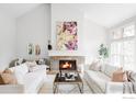 Bright living room with a stone fireplace, vaulted ceiling, and neutral decor, creating a cozy atmosphere at 910 Kalmia Ave, Boulder, CO 80304