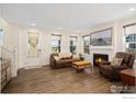 Bright and spacious living room with a fireplace, ample seating, and hardwood floors for a relaxed atmosphere at 97 Westerly Blvd, Erie, CO 80516