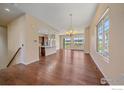 Open-concept living and dining area with hardwood floors, large windows, and abundant natural light at 1130 Summit View Dr, Louisville, CO 80027